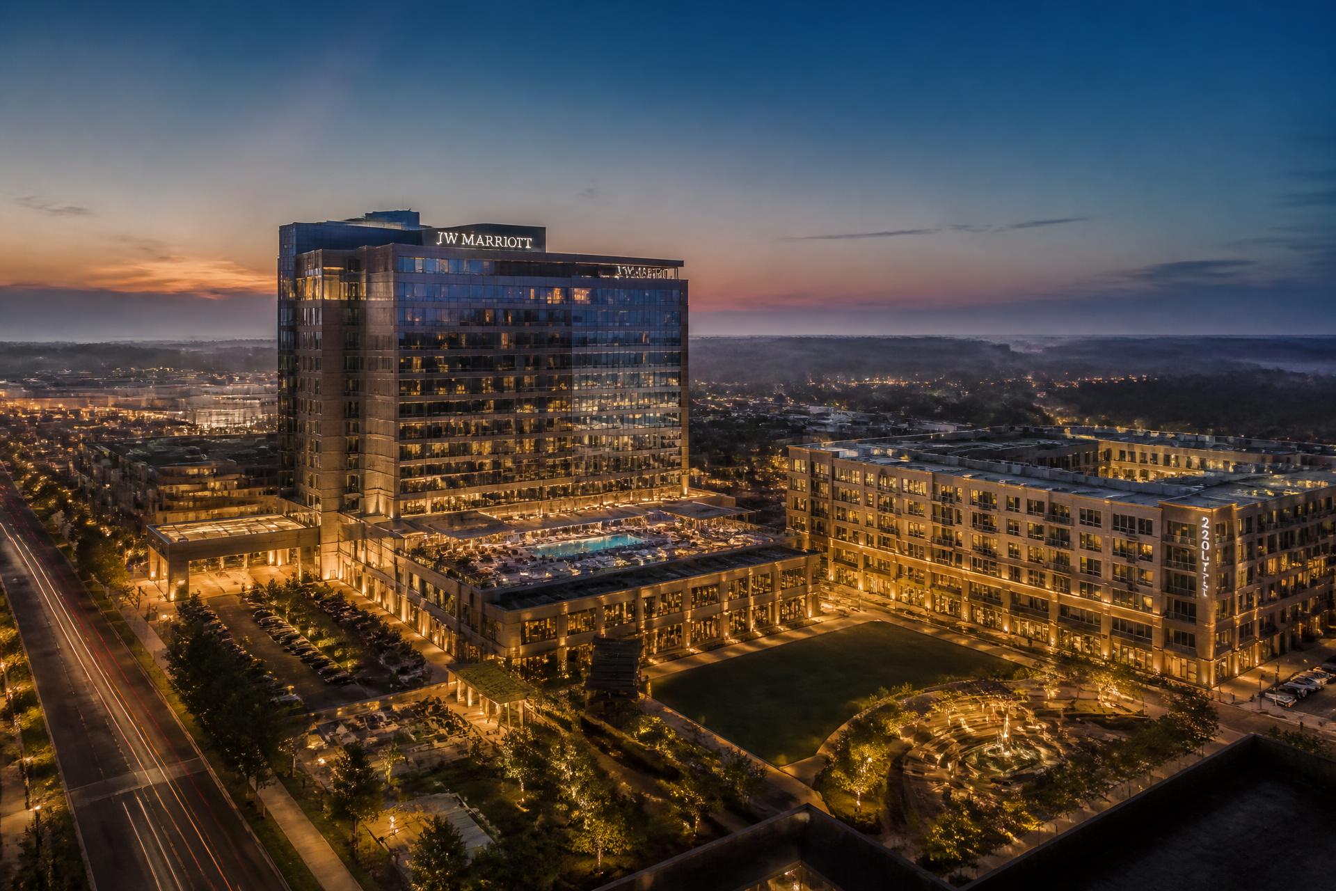 Modern luxury hotel and mixed-use development at dusk